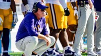 LSU head coach Brian Kelly crouches on the sidelines during a college football game between Ole Miss and LSU at Vaught-Hemingway Stadium in Oxford, Miss., on Saturday, Sept. 27, 2025.