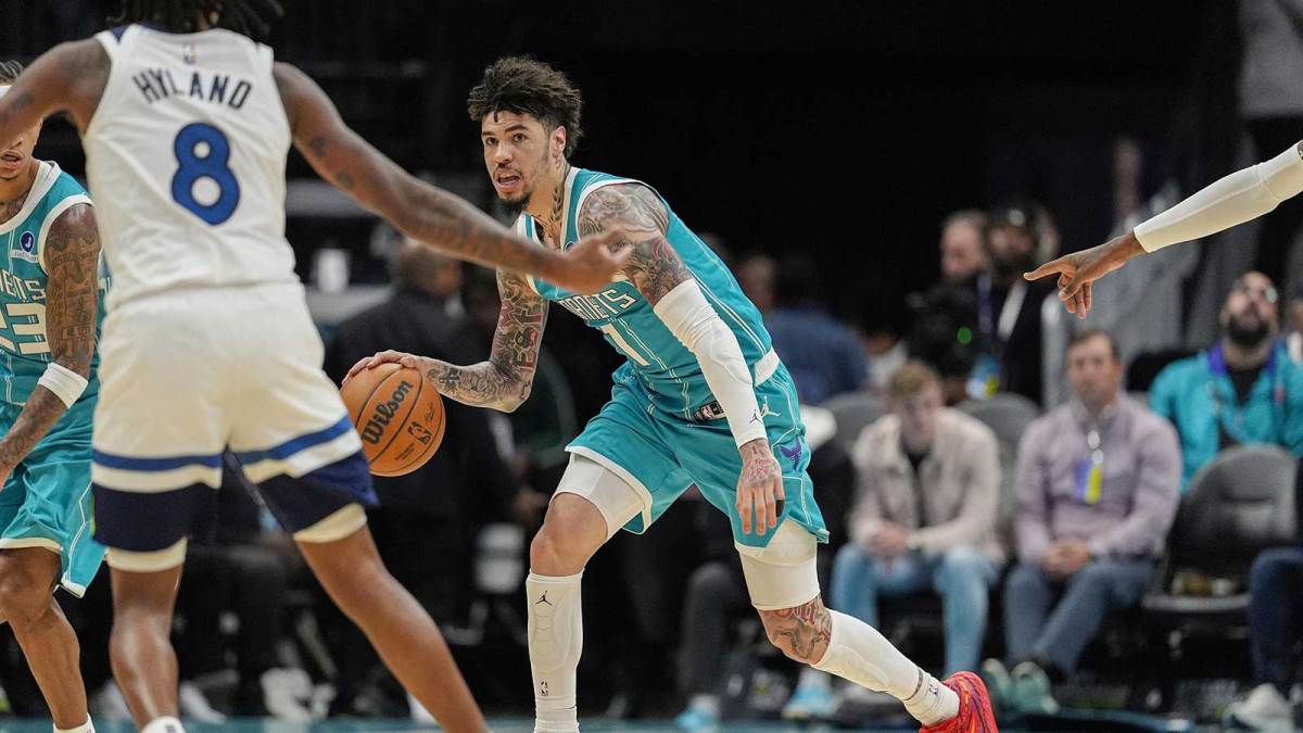 Charlotte Hornets guard LaMelo Ball (1) handles the ball against Minnesota Timberwolves guard Bones Hyland (8) during the second quarter at Spectrum Center.