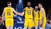 Lakers forward LeBron James (23) and guard Austin Reaves (15) high five after a play against the Oklahoma City Thunder during the second half at Paycom Center