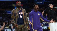Los Angeles Lakers forward LeBron James (left) and son Bronny James (9) react in the second half against the Minnesota Timberwolves at Crypto.com Arena.