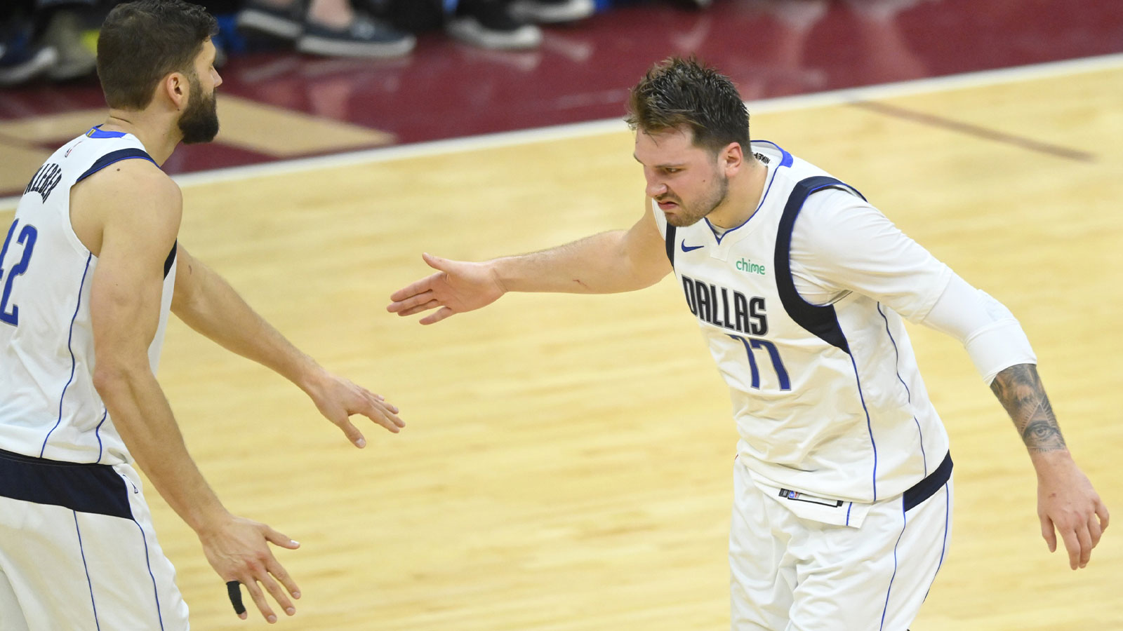 Mavericks guard Luka Doncic (77) celebrates with forward Maxi Kleber (42) in the fourth quarter against the Cleveland Cavaliers at Rocket Mortgage FieldHouse