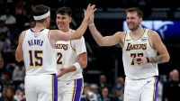 Lakers guard Luka Doncic (77) reacts with guard Austin Reaves (15) during a timeout during the second quarter against the Memphis Grizzlies at FedExForum