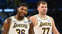 Lakers guard Marcus Smart (36) reacts with Los Angeles Lakers guard Luka Doncic (77) during a time out against the Miami Heat during the second half at Crypto.com Arena with Lakers head coach JJ Redick