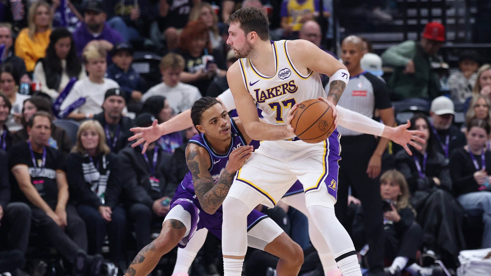 Lakers guard Luka Doncic (77) holds the ball