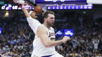 Lakers guard Luka Doncic (77) reacts to a dunk