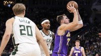 Los Angeles Lakers guard Luka Doncic (77) shoots during the third quarter against the Milwaukee Bucks at Fiserv Forum.