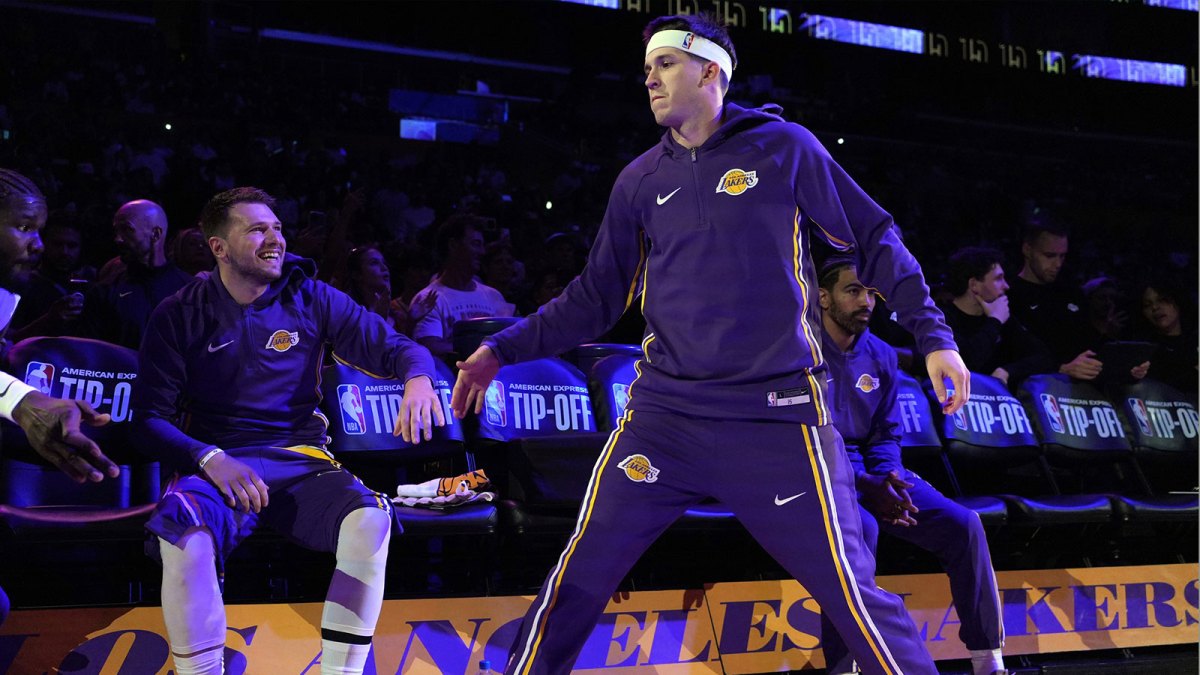 Lakers guard Luka Doncic (left) and guard Austin Reaves (15) interact