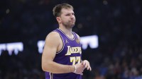 Lakers guard Luka Doncic reacts to a fan