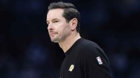 Lakers Head Coach JJ Redick watches from the sideline during the first quarter against the Charlotte Hornets at Spectrum Center