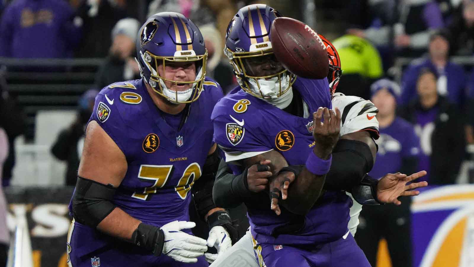 Bengals Joseph Ossai (58) helps take down Ravens Lamar Jackson (8) for the Bengals to take the ball during their game against the Ravens at M&T Bank Stadium on Thanksgiving Thursday November 27, 2025.