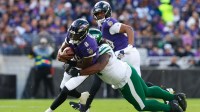 Baltimore Ravens quarterback Lamar Jackson (8) rushes and is tackled by New York Jets defensive tackle Jowon Briggs (91) during the second quarter at M&T Bank Stadium