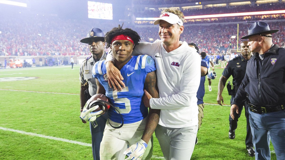 Mississippi Rebels head coach Lane Kiffin embraces running back Kewan Lacy (5) after defeating the Florida Gators at Vaught-Hemingway Stadium.