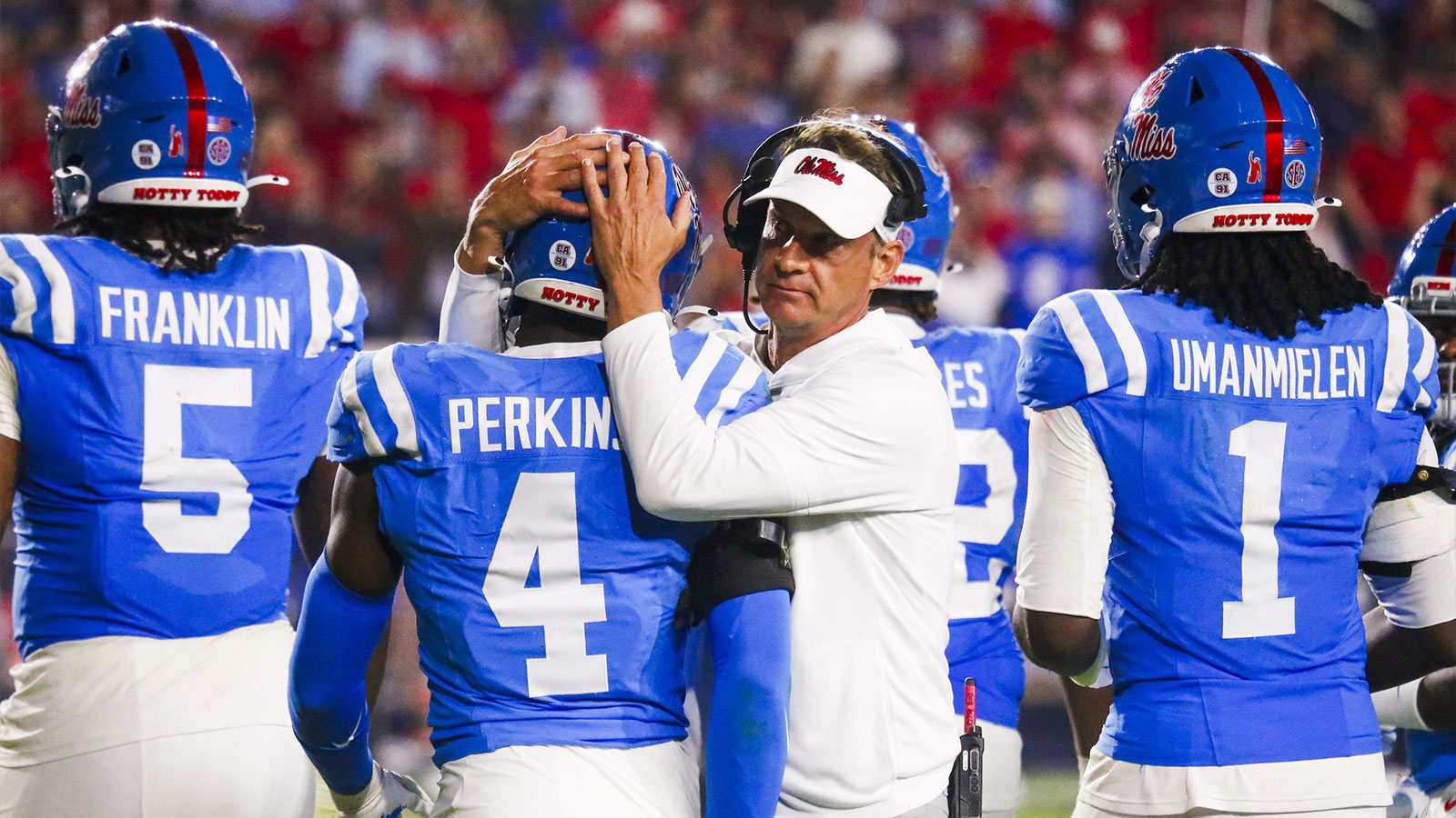 Mississippi Rebels head coach Lane Kiffin embraces linebacker Suntarine Perkins (4) during the second half against the Florida Gators at Vaught-Hemingway Stadium.