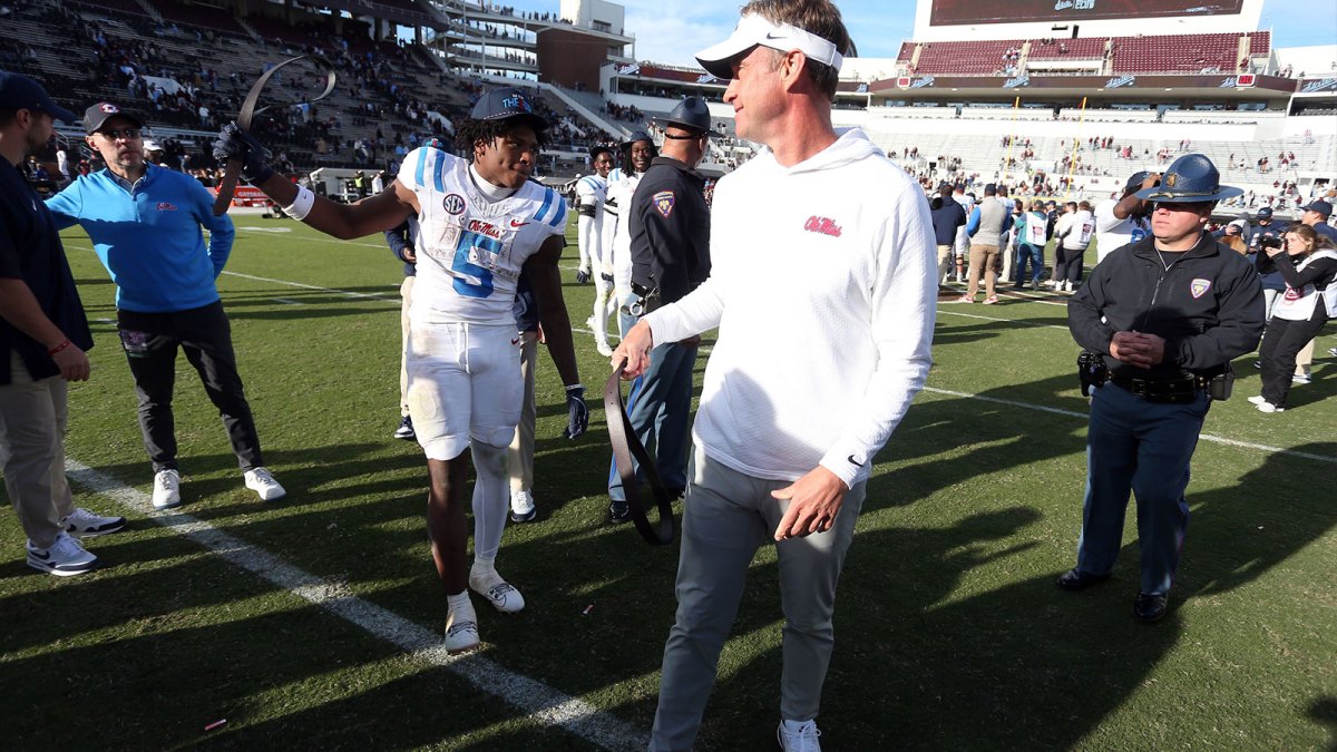 Mississippi Rebels running back Kewan Lacy (5) and head coach Lane Kiffin celebrate after defeating against the Mississippi State Bulldogs at Davis Wade Stadium at Scott Field