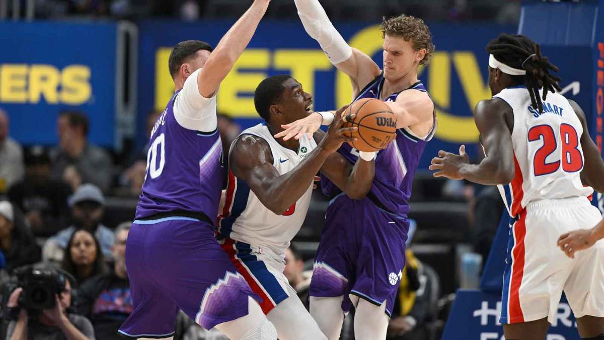 Detroit Pistons center Jalen Duren (0) is fouled by Utah Jazz center Jusuf Nurkic (30) and forward Lauri Markkanen (23) while driving to the basket in the first quarter at Little Caesars Arena.