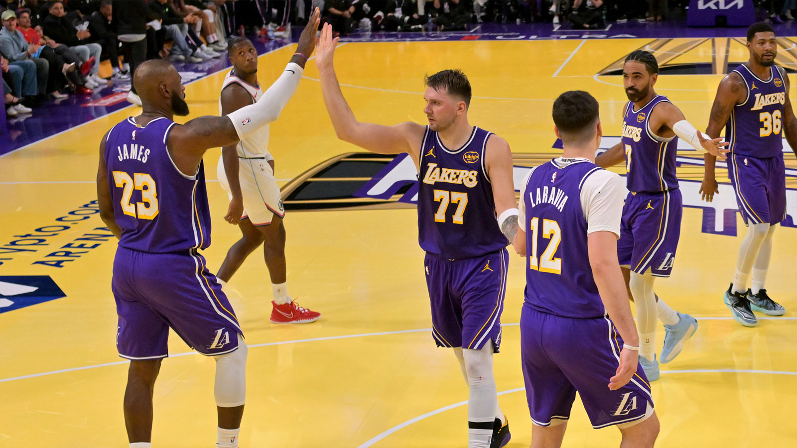 Los Angeles Lakers forward LeBron James (23) and guard Luka Doncic (77) high five during a time out in the second half against the Los Angeles Clippers at Crypto.com Arena. 