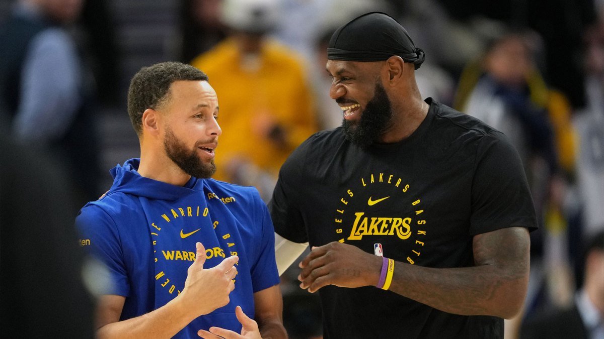 Golden State Warriors guard Stephen Curry (left) and Los Angeles Lakers forward LeBron James (right) talk before the game at Chase Center.