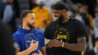 Golden State Warriors guard Stephen Curry (left) and Los Angeles Lakers forward LeBron James (right) talk before the game at Chase Center.