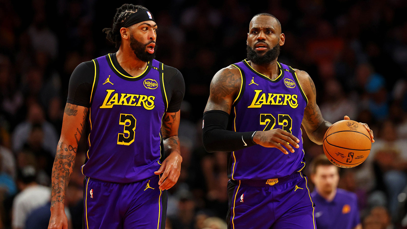 Los Angeles Lakers forward Anthony Davis (3) and forward LeBron James (23) walks to the bench during the first half against the Phoenix Suns at Footprint Center.
