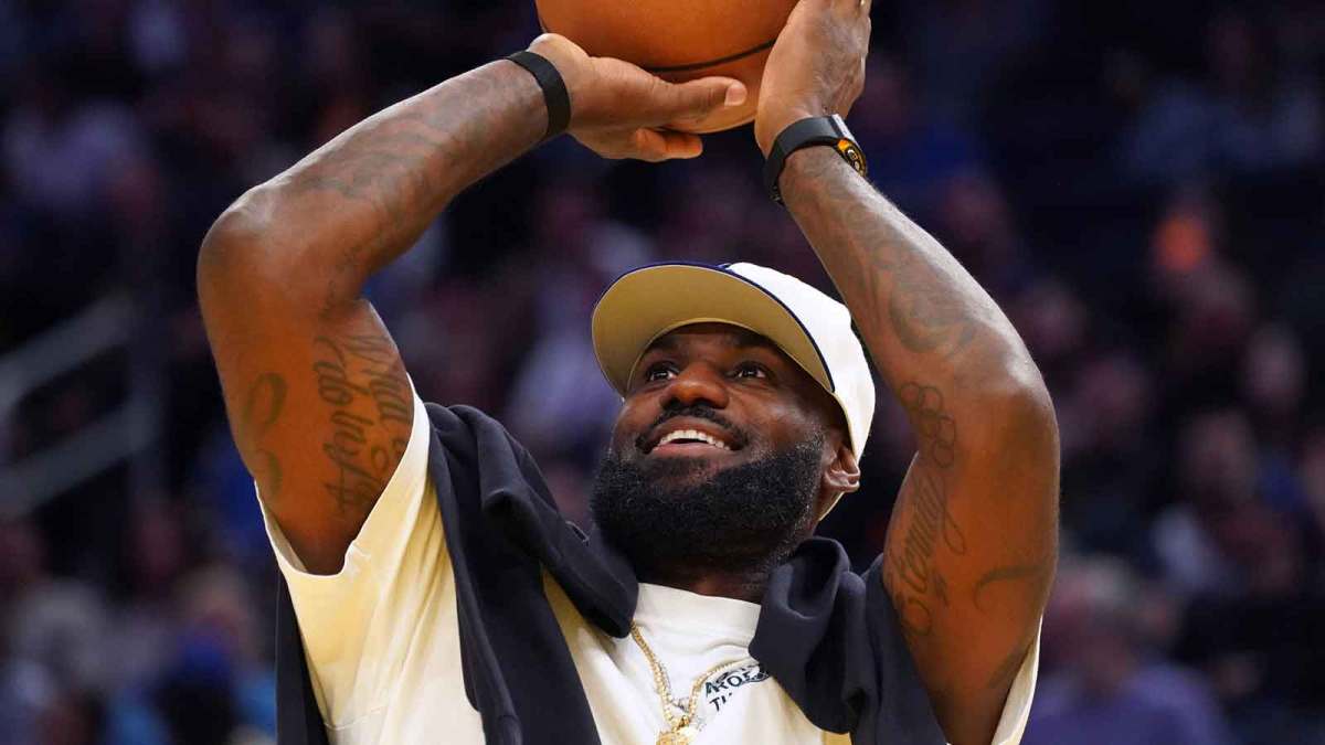Los Angeles Lakers forward LeBron James (23), wearing a Los Angeles Dodgers hat, watches from the sideline during a break against the Golden State Warriors in the third quarter at Chase Center.