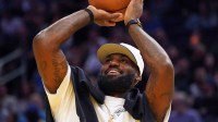 Los Angeles Lakers forward LeBron James (23), wearing a Los Angeles Dodgers hat, watches from the sideline during a break against the Golden State Warriors in the third quarter at Chase Center.