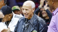Former Seattle Supersonics head coach Lenny Wilkens acknowledges the fans after being introduced during a third quarter timeout of a preseason game between the Utah Jazz and LA Clippers at Climate Pledge Arena.