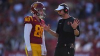 USC Trojans head coach Lincoln (right) talks with Southern California Trojans punter Sam Johnson (80) in the first half against the Missouri State Bears at United Airlines Field at Los Angeles Memorial Coliseum.