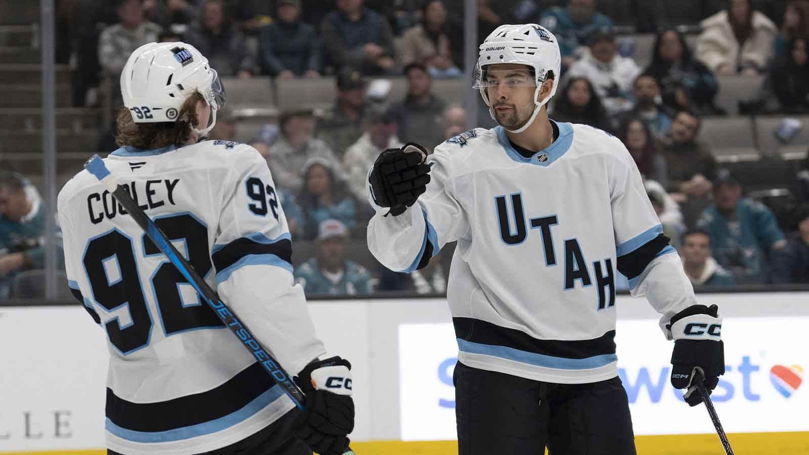 Utah Hockey Club center Logan Cooley (92) celebrates with right wing Dylan Guenther (11) during the first period against the San Jose Sharks at SAP Center at San Jose.