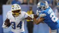 Los Angeles Chargers running back Jaret Patterson (34) carries the ball against Detroit Lions safety Ian Kennelly (27) during the second half at Tom Benson Hall of Fame Stadium.