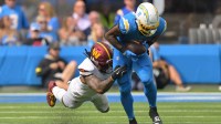 Los Angeles Chargers running back Omarion Hampton (8) makes a catch against Washington Commanders linebacker Frankie Luvu (4) in the first half at SoFi Stadium.