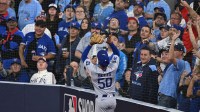Los Angeles Dodgers shortstop Mookie Betts (50) makes a catch against Toronto Blue Jays designated hitter Bo Bichette (11) in the eighth inning during game six of the 2025 MLB World Series at Rogers Centre. Mandatory Credit: Dan Hamilton-Imagn Images