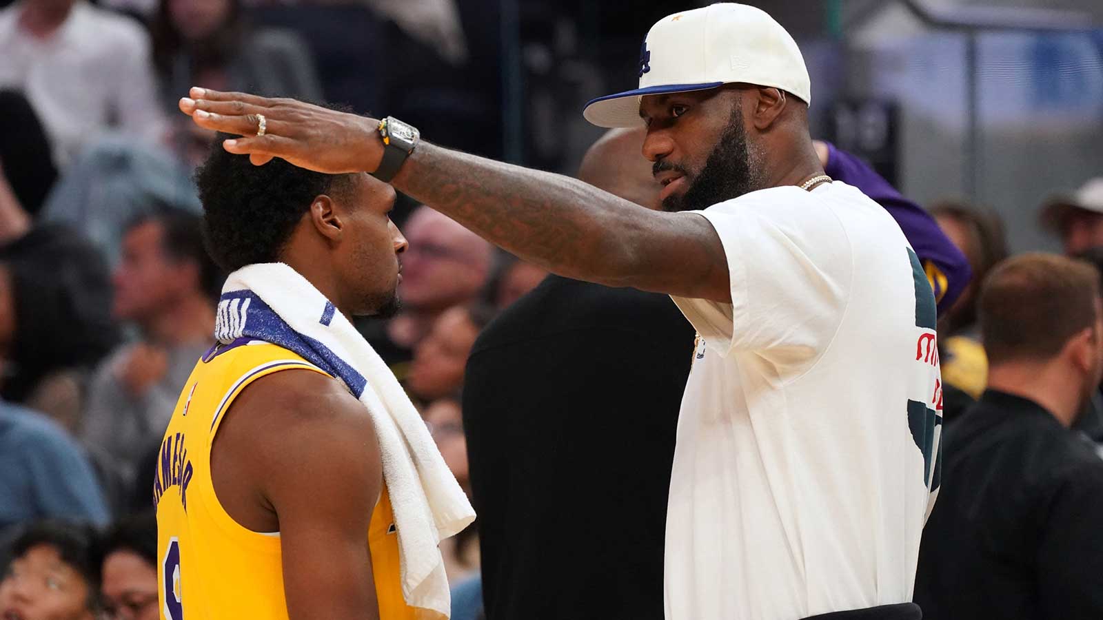 Los Angeles Lakers forward LeBron James (23) talks with son, guard Bronny James (9), during a break in the fourth quarter against the Golden State Warriors at Chase Center.