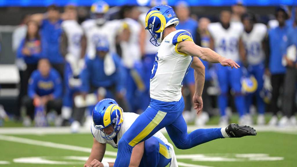Los Angeles Rams punter Ethan Evans (42) sets the ball as place kicker Joshua Karty (16) hits the game winning field goal in the fourth quarter against the San Francisco 49ers at SoFi Stadium.