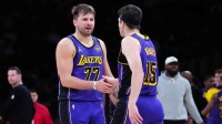 Los Angeles Lakers guard Luka Doncic (77) and guard Austin Reaves (15) react against the San Antonio Spurs in the first half at Crypto.com Arena.