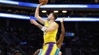 Los Angeles Lakers forward/guard Luka Doncic (77) floats a shot towards the basket during the first quarter against the Charlotte Hornets at Spectrum Center.
