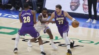 Los Angeles Lakers guard Luka Doncic (77) moves the ball around Oklahoma City Thunder guard Cason Wallace (22) during the first quarter at Paycom Center.