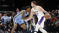 Los Angeles Lakers guard Luka Doncic (77) dribbles as Memphis Grizzlies guard Ja Morant (12) defends during the third quarter at FedExForum.