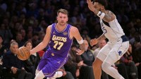 Los Angeles Lakers guard Luka Doncic (77) is defended by Dallas Mavericks forward P.J. Washington (25) as he drives to the basket in the first half at Crypto.com Arena.