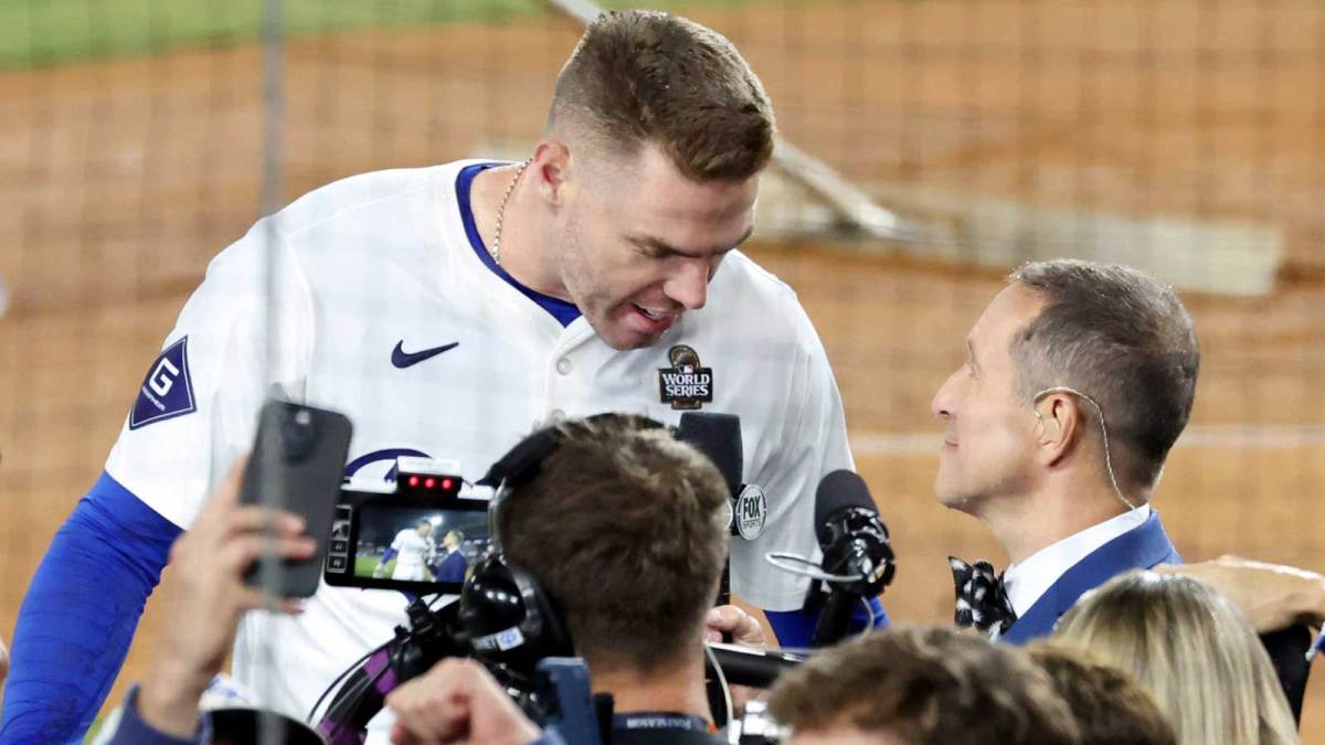 Fox Sports field reporter Ken Rosenthal interviews Los Angeles Dodgers first baseman Freddie Freeman (5) after the win against the New York Yankees during game one of the 2024 MLB World Series at Dodger Stadium.