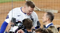 Fox Sports field reporter Ken Rosenthal interviews Los Angeles Dodgers first baseman Freddie Freeman (5) after the win against the New York Yankees during game one of the 2024 MLB World Series at Dodger Stadium.