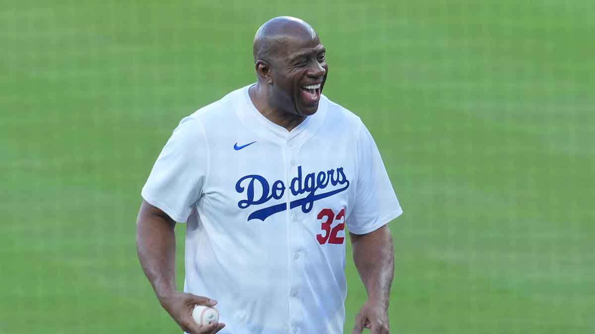 Los Angeles Dodgers co owner Magic Johnson reacts before throwing the ceremonial first pitch before game five of the 2025 MLB World Series between the Toronto Blue Jays and the Los Angeles Dodgers at Dodger Stadium.