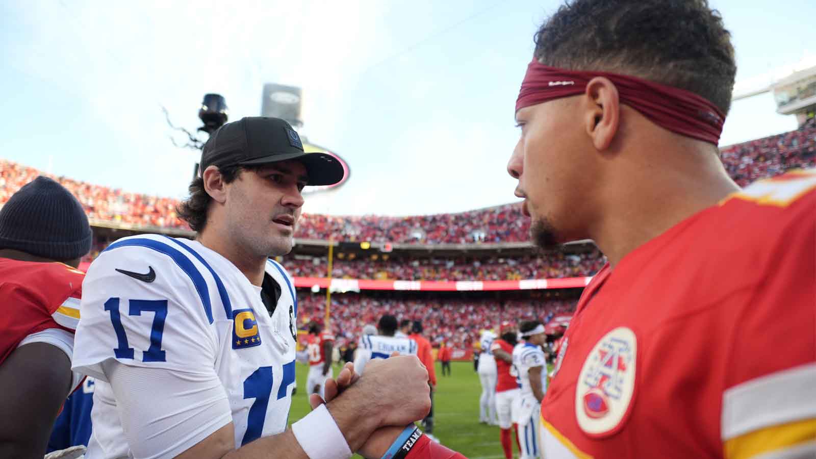 Indianapolis Colts quarterback Daniel Jones (17) and Kansas City Chiefs quarterback Patrick Mahomes (15) meet on field after the game at GEHA Field at Arrowhead Stadium. 