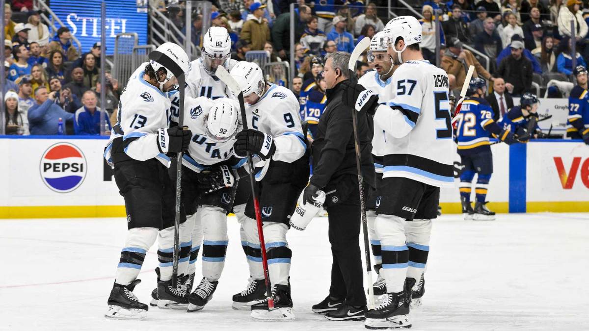 Utah Mammoth center Logan Cooley (92) is helped off the ice by left wing Brandon Tanev (13) and center Clayton Keller (9) after he was kneed by St. Louis Blues right wing Alexey Toropchenko (not pictured) during the third period at Enterprise Center.