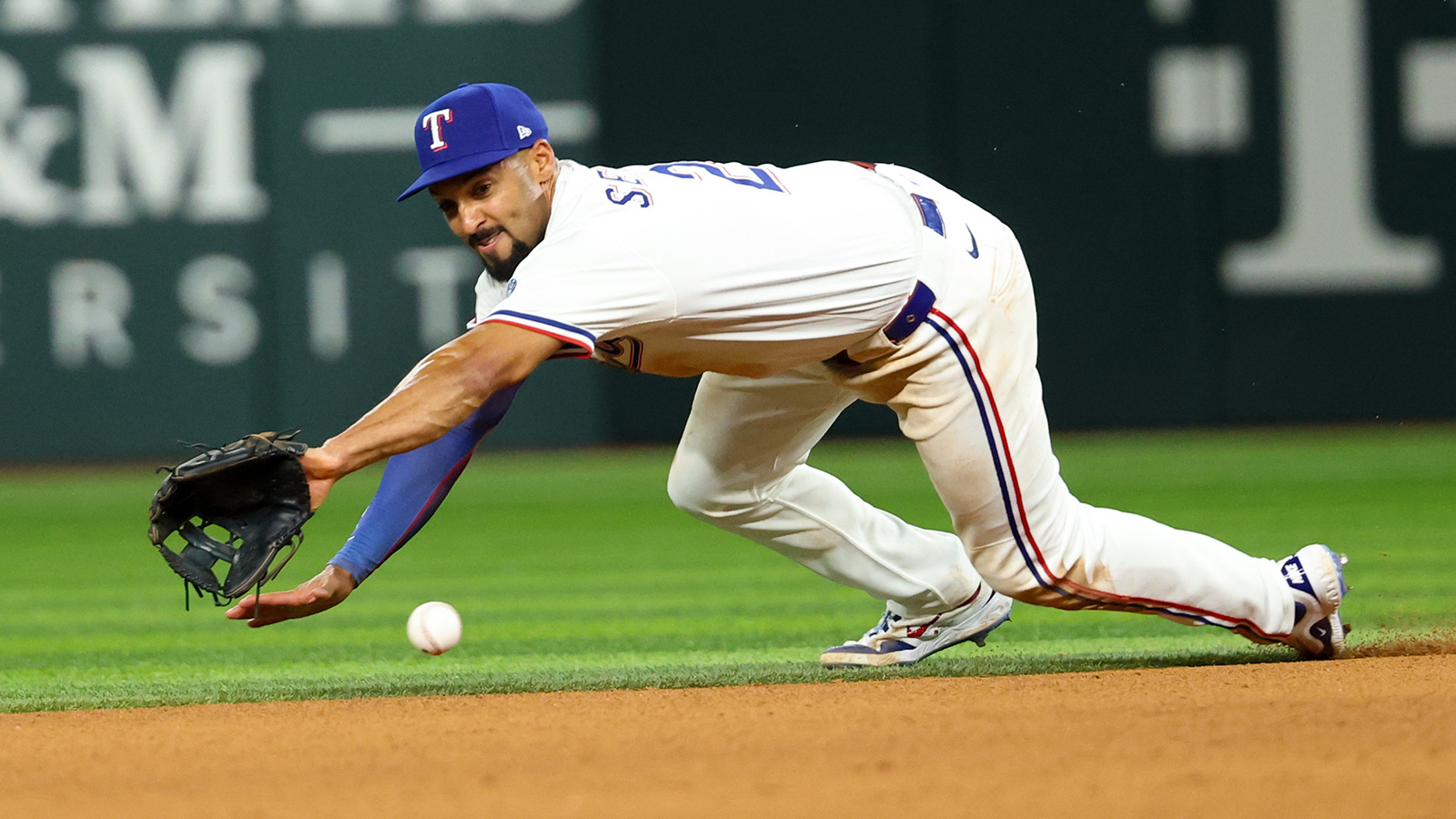 Texas Rangers second baseman Marcus Semien (2) dives for but cannot field a ground ball during the seventh inning against the Baltimore Orioles at Globe Life Field.