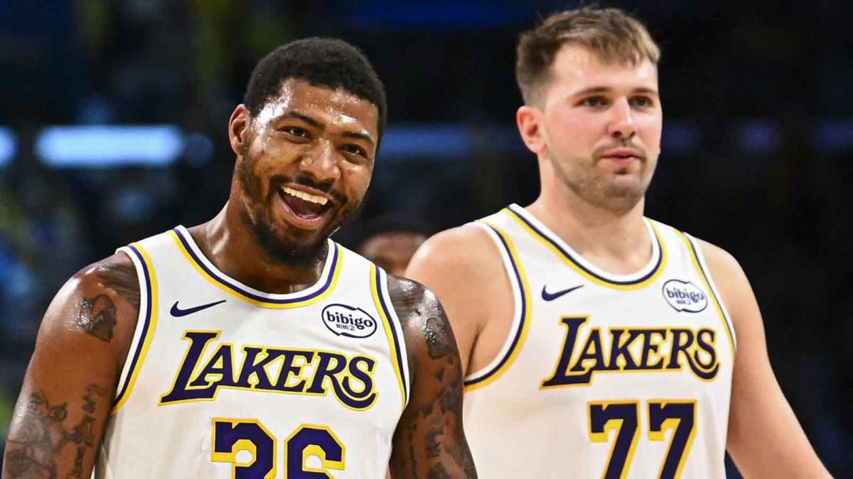 Los Angeles Lakers guard Marcus Smart (36) reacts with Los Angeles Lakers guard Luka Doncic (77) during a time out against the Miami Heat during the second half at Crypto.com Arena.