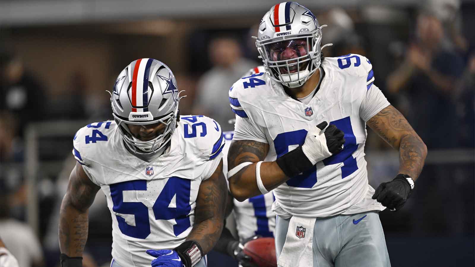 Dallas Cowboys defensive end Marshawn Kneeland (94) celebrates with defensive end Sam Williams (54) after recovering a blocked punt for a touchdown against the Arizona Cardinals in the first half at AT&T Stadium. 