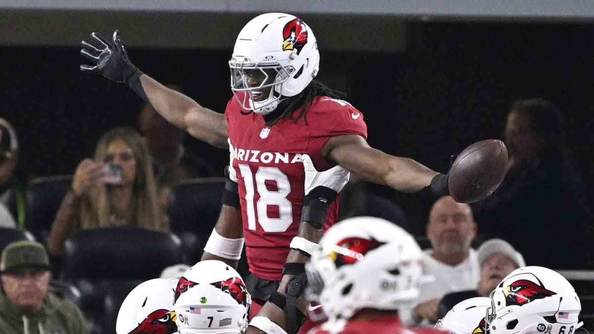 Arizona Cardinals wide receiver Marvin Harrison Jr. (18) celebrates with teammates after scoring a touchdown against the Dallas Cowboys in the first half at AT&T Stadium.
