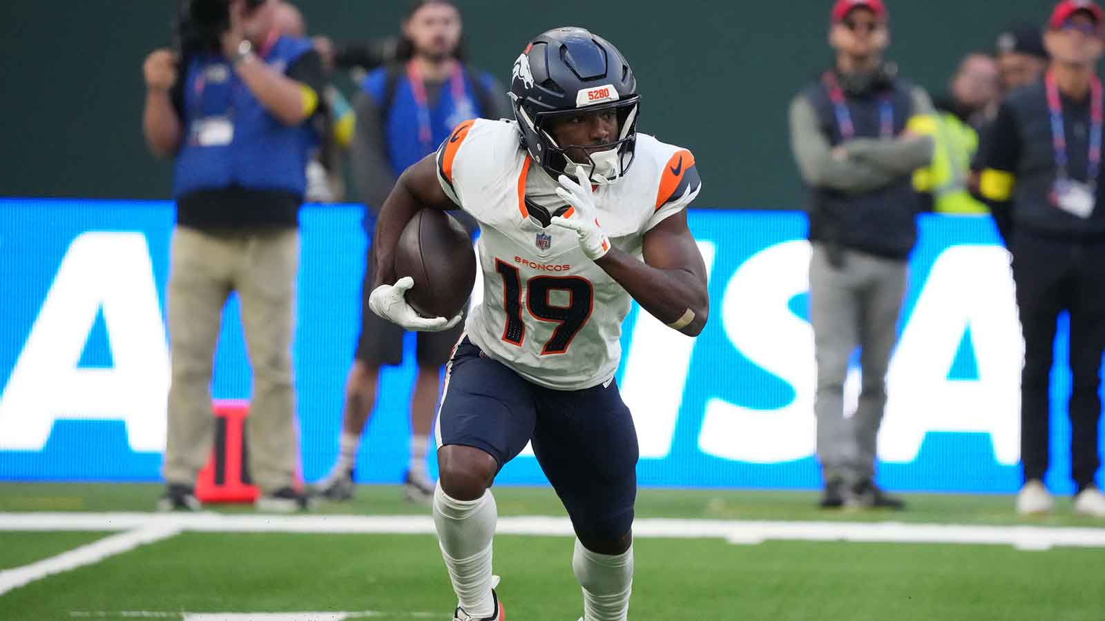 Denver Broncos wide receiver Marvin Mims Jr. (19) carries the ball against the New York Jets during an NFL International Series game at Tottenham Hotspur Stadium.