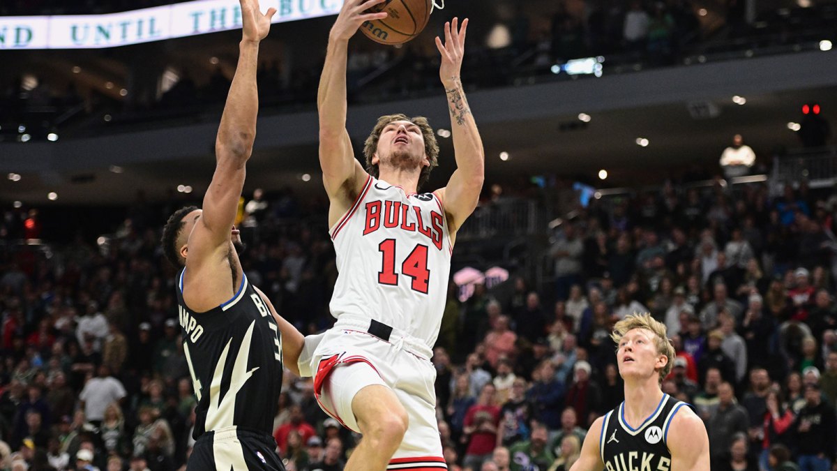 Nov 7, 2025; Milwaukee, Wisconsin, USA; Chicago Bulls forward Matas Buzelis (14) takes a shot between Milwaukee Bucks forward Giannis Antetokounmpo (34) and guard AJ Green (20) in the first quarter at Fiserv Forum. Mandatory Credit: Benny Sieu-Imagn Images