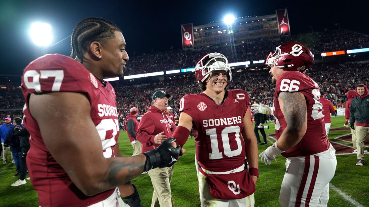 Oklahoma Sooners quarterback John Mateer (10) celebrates with Oklahoma Sooners defensive lineman Marvin Jones Jr. (97) and Oklahoma Sooners offensive lineman Derek Simmons (66) after a college football game between the University of Oklahoma Sooners (OU) and the LSU Tigers at Gaylord Family – Oklahoma Memorial Stadium in Norman, Okla., Saturday, Nov. 29, 2025. Oklahoma won 17-13.